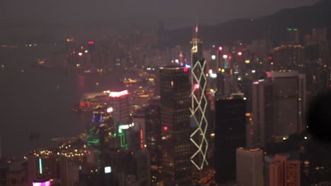 progressive focus shot of hong kong city illuminated at night.