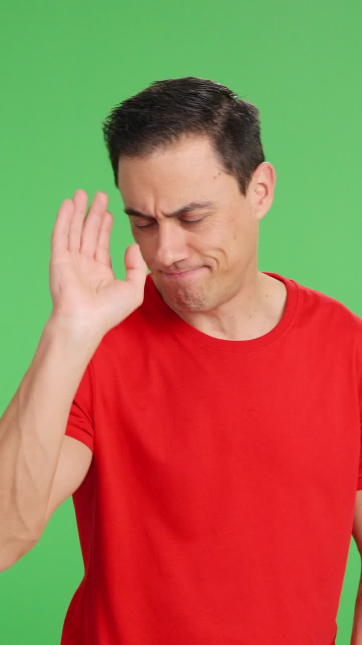 Man pointing at green screen with disapproving expression