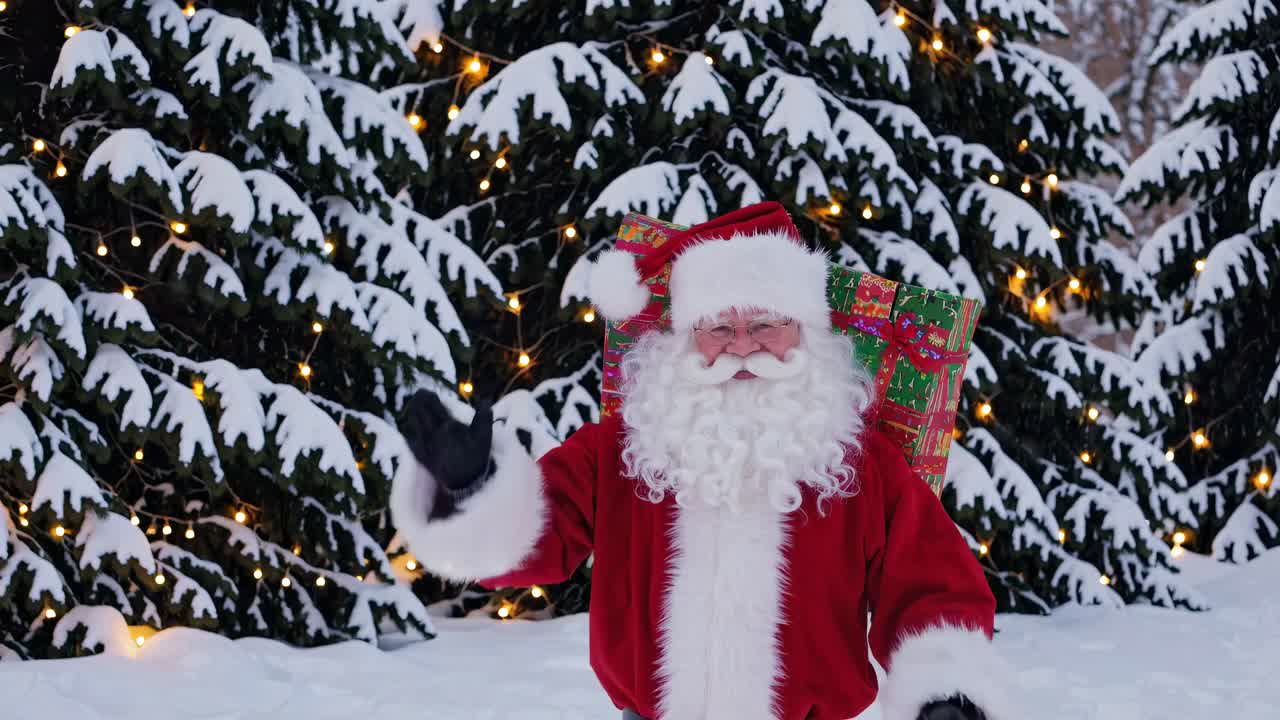 Festive video scene with Santa in a snowy forest, surrounded by lit trees