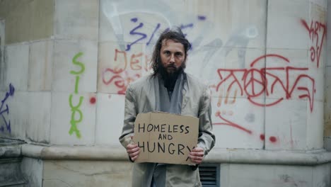 Slow-Motion-video-of-a-homeless-and-scruffy-man-begging-for-money-or-food-so-then-he-can-eat-and-survive-for-the-day