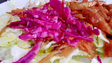 Ultra-Slow-motion:Fresh-mixed-green-salad-in-bowl-on-wooden-table-close-up