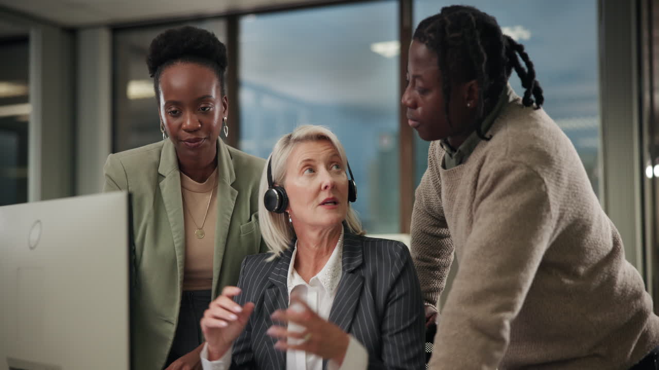 Business team collaborating in front of computer