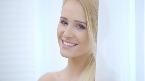 Pretty-Smiling-Woman-Behind-White-Curtain