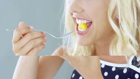 Beautiful-woman-eating-fruit-salad-in-bowl