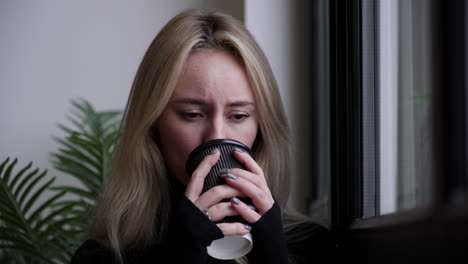 blonde woman drinking coffee