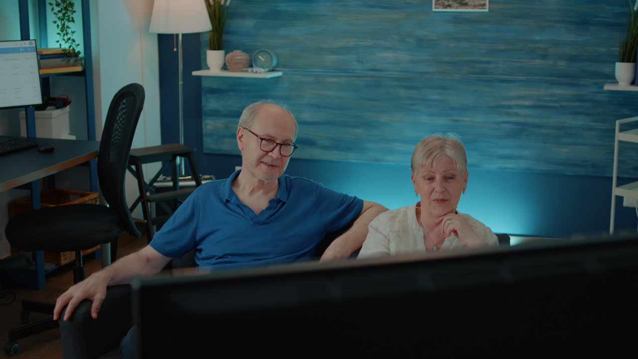 Elderly Couple Relaxing at Home Watching TV