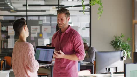 Happy-caucasian-business-people-discussing-work-during-meeting-at-office