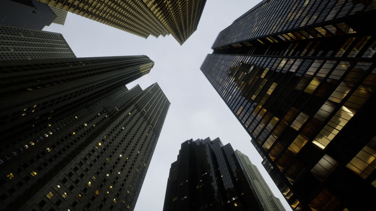 Tall buildings reach towards the sky in a modern city at dusk