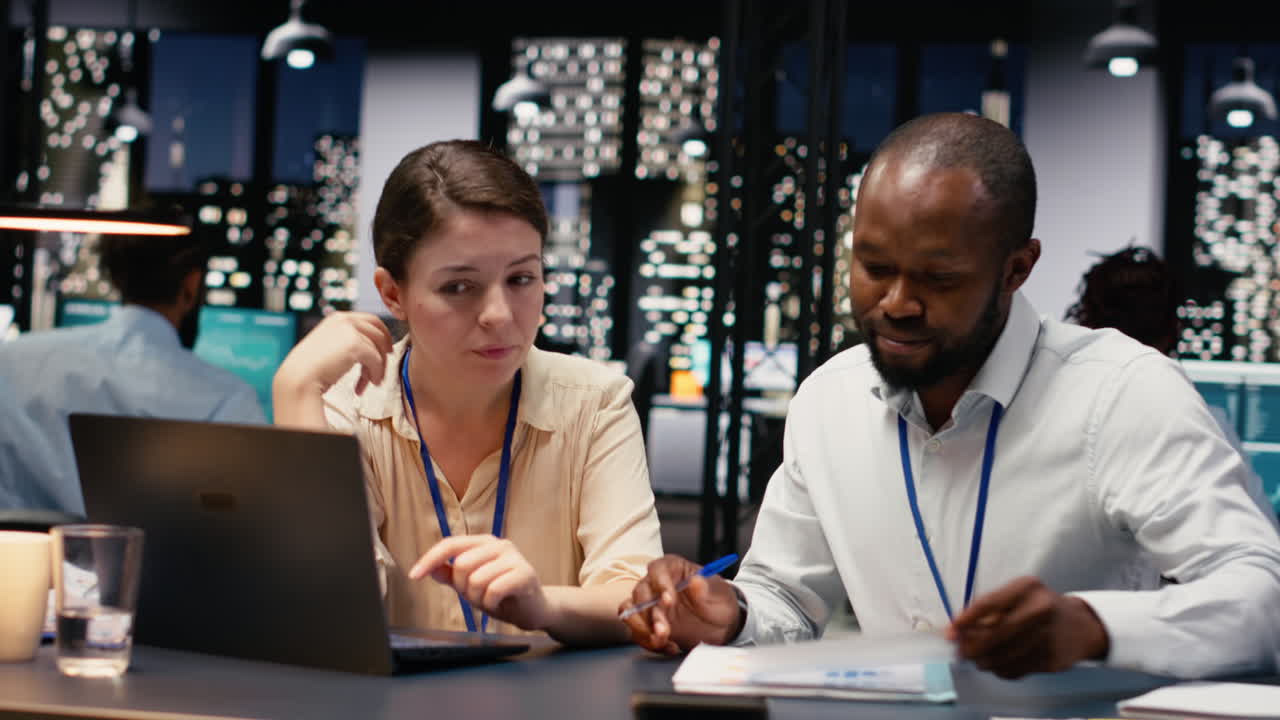 Diverse coworkers on laptop managing tasks and documenting project progress