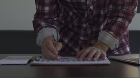 concepto de finanzas y economía cuentas de gastos mensuales y liquidación de deudas jóvenes usan calculadoras. cuentan sus ingresos domésticos y documentos fiscales en casa.