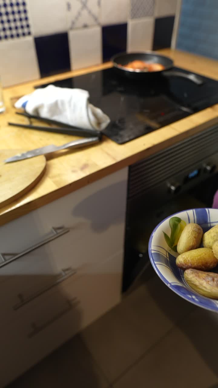 Cooking Roasted Potatoes and Fish in a Kitchen