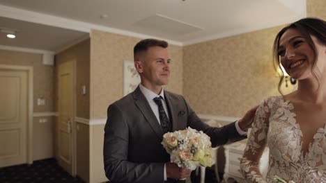 newlyweds young caucasian bride and groom first meeting at wedding day, making a kiss indoors