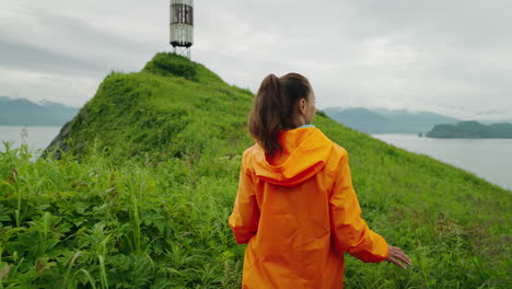 woman hiking on a hilltop by the ocean