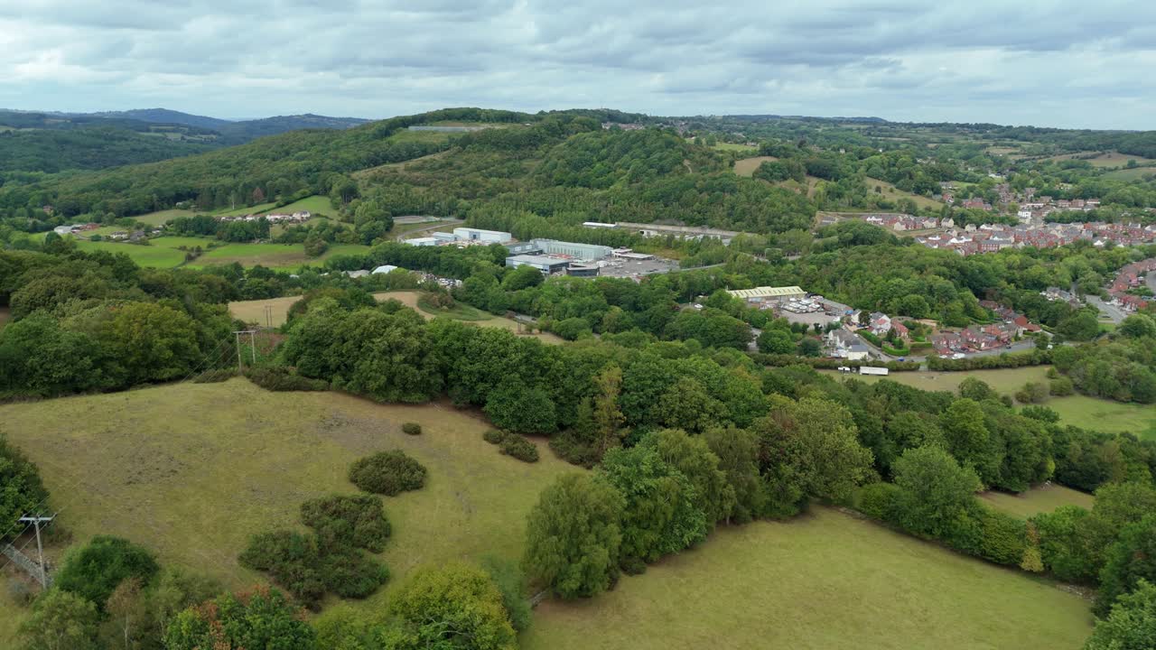 Aerial drone view of rolling green fields and hills with mountains in Ambergate Derbyshire Dales United Kingdom on a sunny summer day