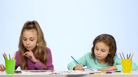 two girls drawing together