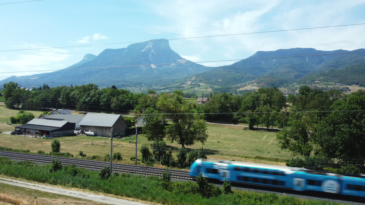 Train travels through a picturesque mountain valley
