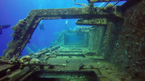 Diving-through-underwater-ship-wreck-in-the-red-sea