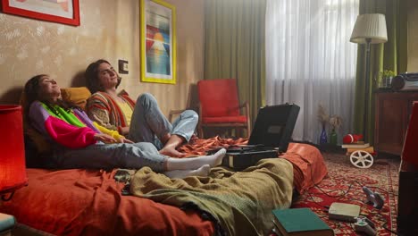 couple relaxing in a vintage bedroom, listening to music on a record player