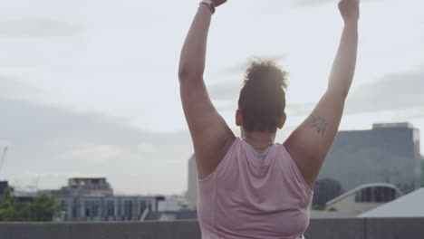 woman stretching on rooftop