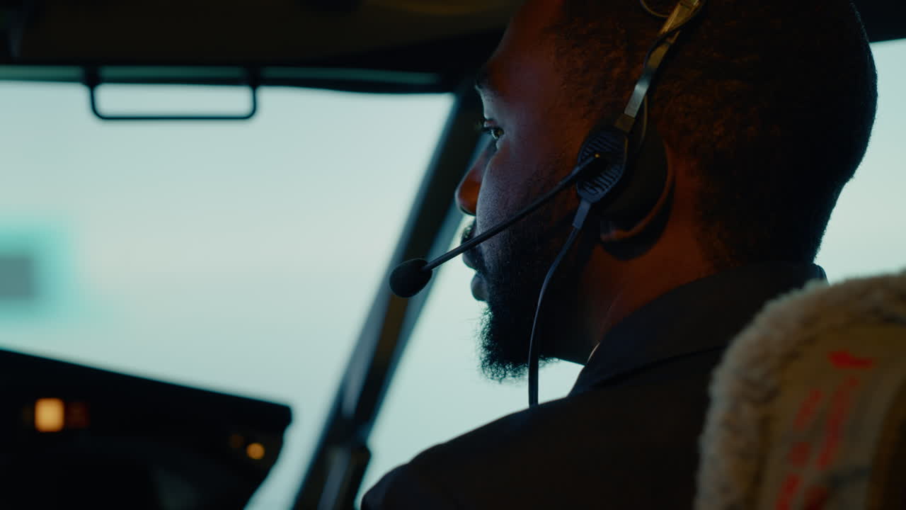 African american copilot preparing to takeoff and fly plane