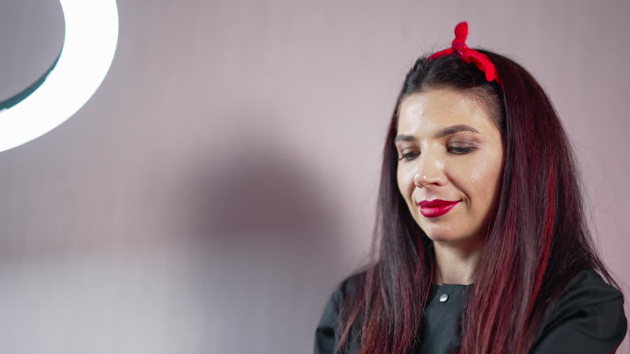 Permanent makeup teacher showing how to do permanent makeup at the studio. Very beautiful eyebrow master. Make up artist at work