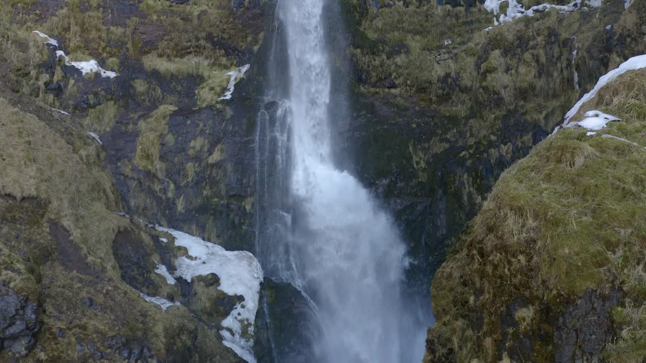 Flying straight up in slow motion close to a waterfall in south Iceland.