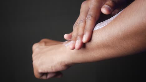 person applying lotion on arm