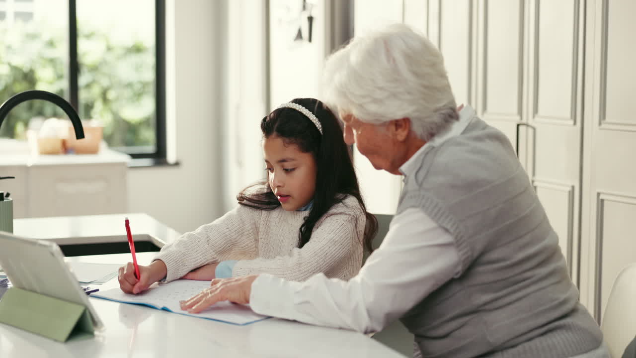 Grandmother helping her grandchild with schoolwork at home
