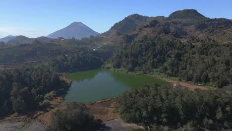 Aerial-view-of-green-water-lake-with-beautiful-tropical-landscape-mountain-and-hill