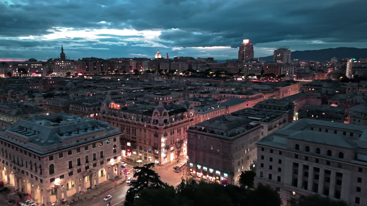 Twilight aerial view over lit up Via XX Settembre in Genoa historic city center