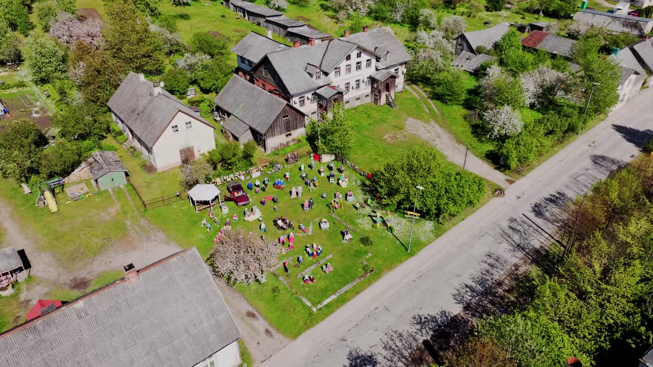 Creative cultural garden, Sabile showing handmade straw doll collection on grass