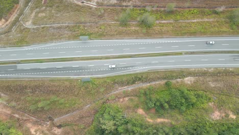 beautiful drone view of bau to lundu pan borneo highway during morning sunset with mountain and valley, green forest,sarawak, borneo.