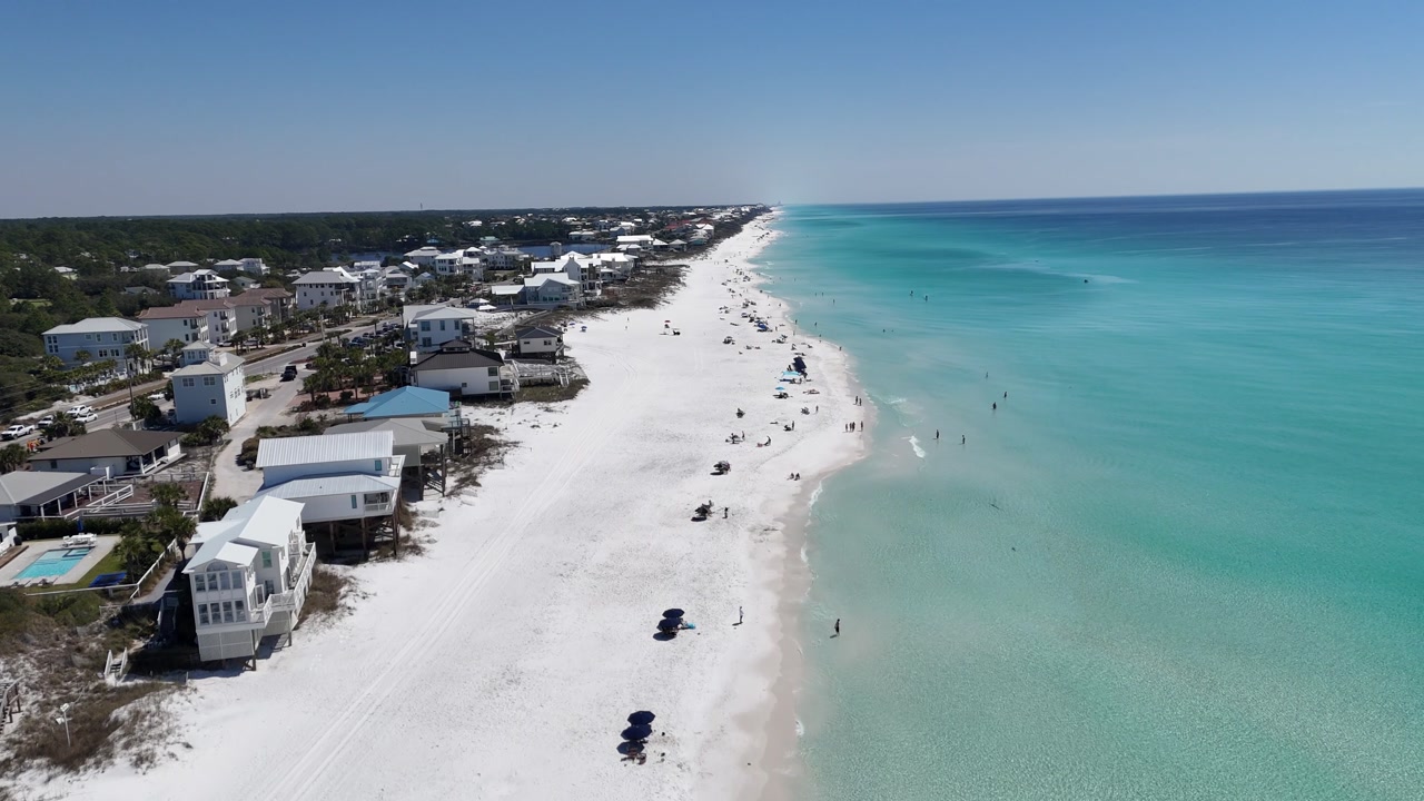 Coastal residential strip on aerial view with houses aligned along white Dune Allen Beach, Santa Rosa Beach, Florida, USA