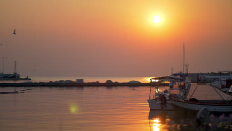 Waterscape-with-harbour-and-boats-at-sunset