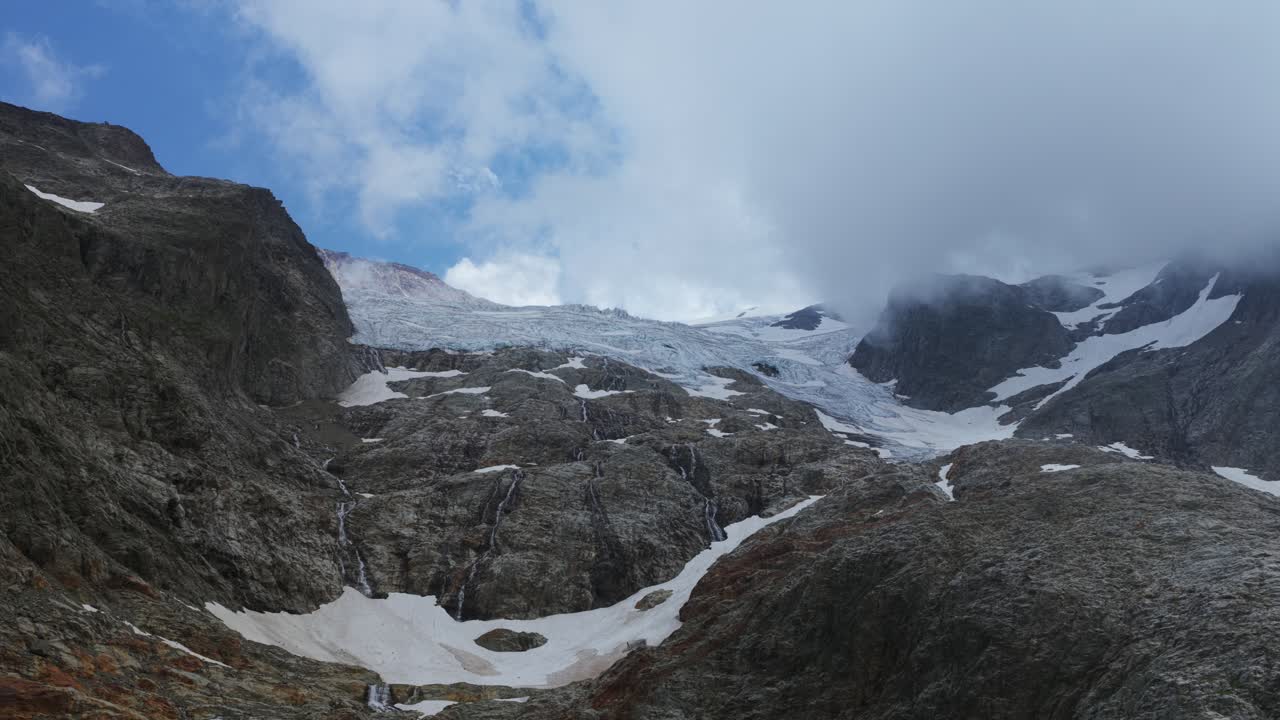 Overcast Sky Over Swiss Alpine Mountain Glacier Near Susten Pass At Sunrise In Switzerland. Aerial Shot