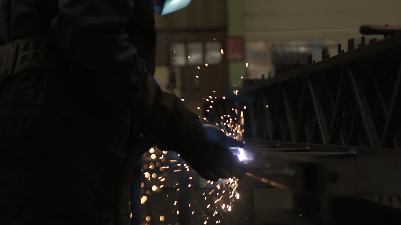 Welder welding, Knee-high Shot. Slow Motion