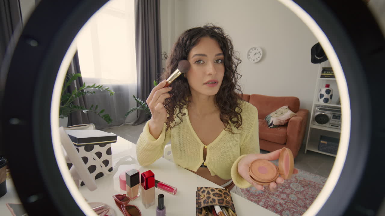 Female Beauty Blogger Applying Bronzing Powder during Makeup Tutorial