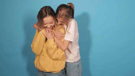 two happy women hugging