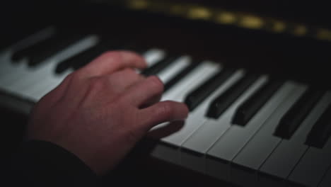 close-up of hands playing piano