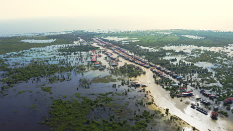 sun reflecting off the flooded fishing village kompong phluk, cambodia, panoramic aerial dolly