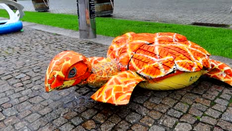 colorful turtle made of old and used car tires in porto, portugal