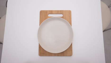 empty plate on wooden cutting board