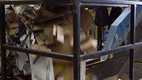 cardboard to recycle loads onto a conveyor belt, shot on r3d