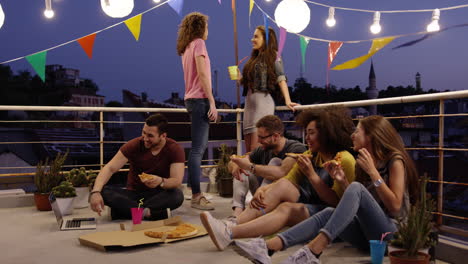 rooftop pizza party friends enjoying