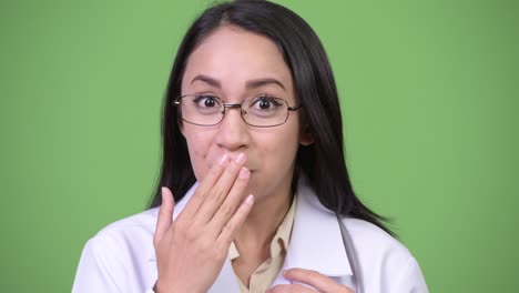 young beautiful asian woman doctor looking shocked