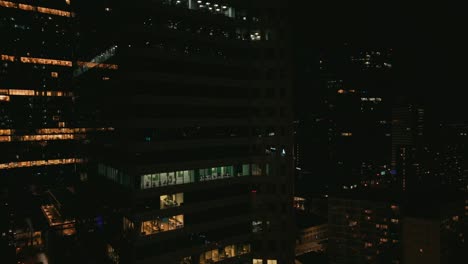 close-up drone trucking shots of city lights reflected in a modern skyscraper