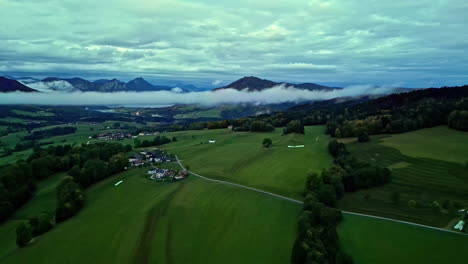 aerial panning view of morning clouds in the valley between the alps in austria