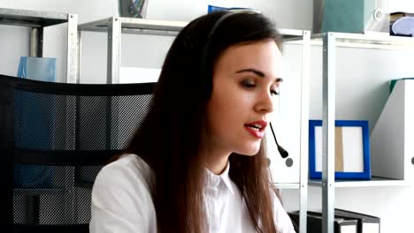 woman speaking on headset in modern office