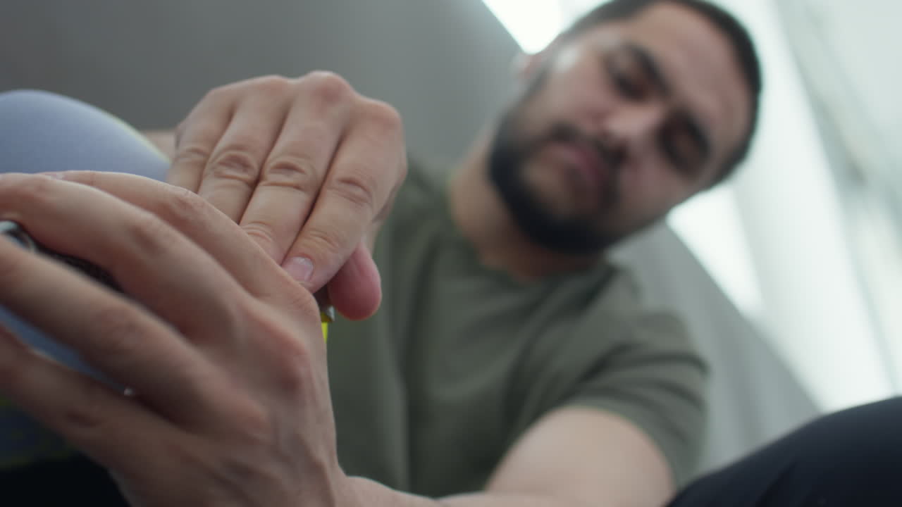 Man Using Wrench while Putting on Prosthetic Leg