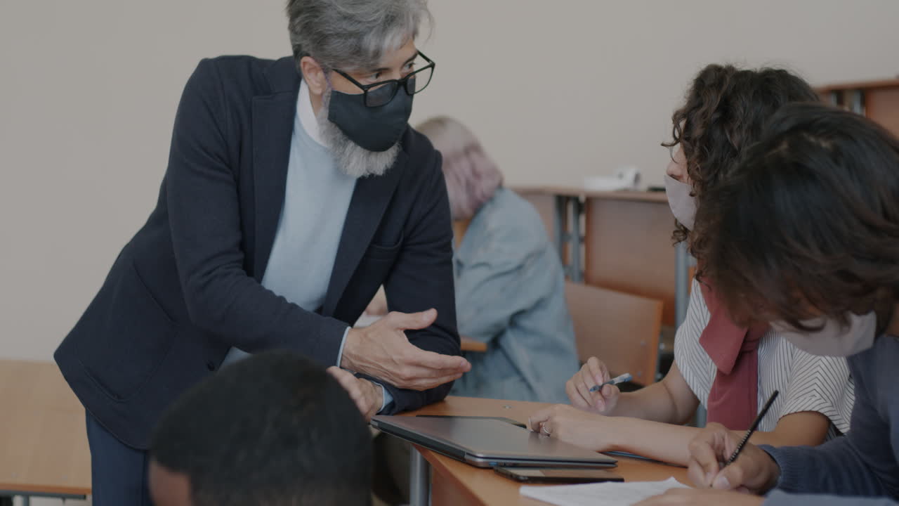 Teacher assisting students in a classroom setting